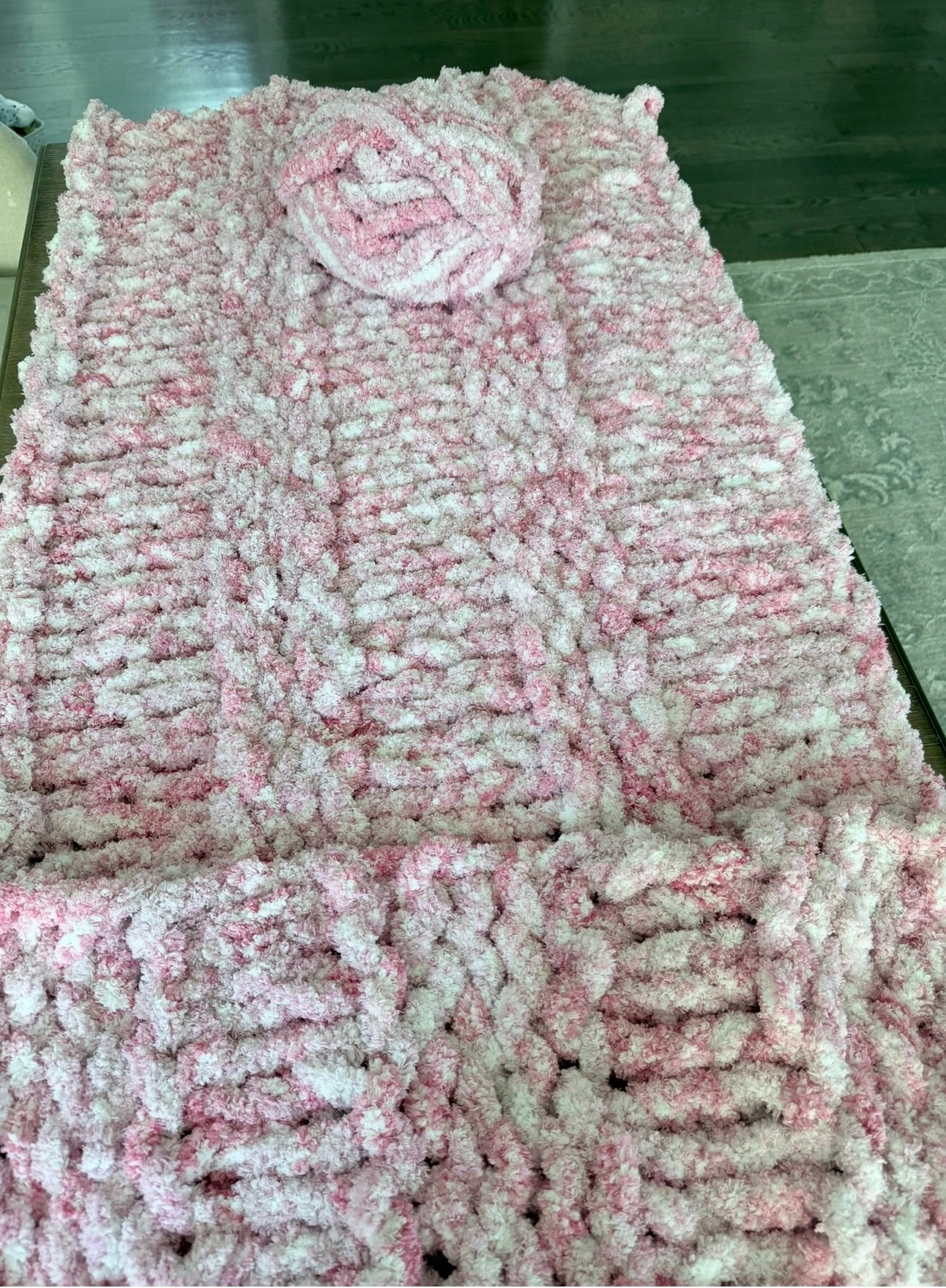 Hand-knitted pink and white chenille blanket with rose motif — made by the designer
