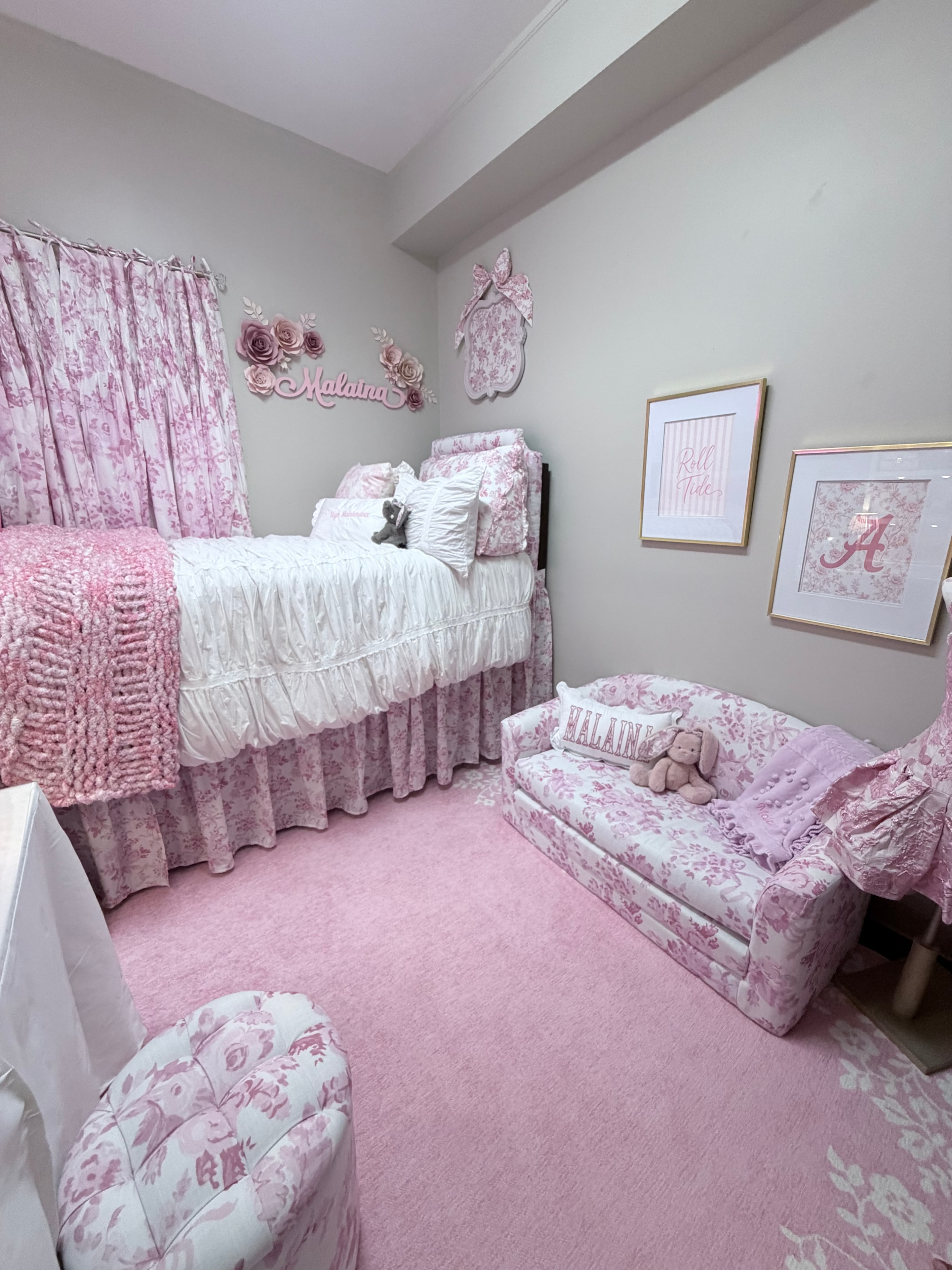 Hand-knitted pink and white blanket draped at the foot of the bed in the finished dorm room