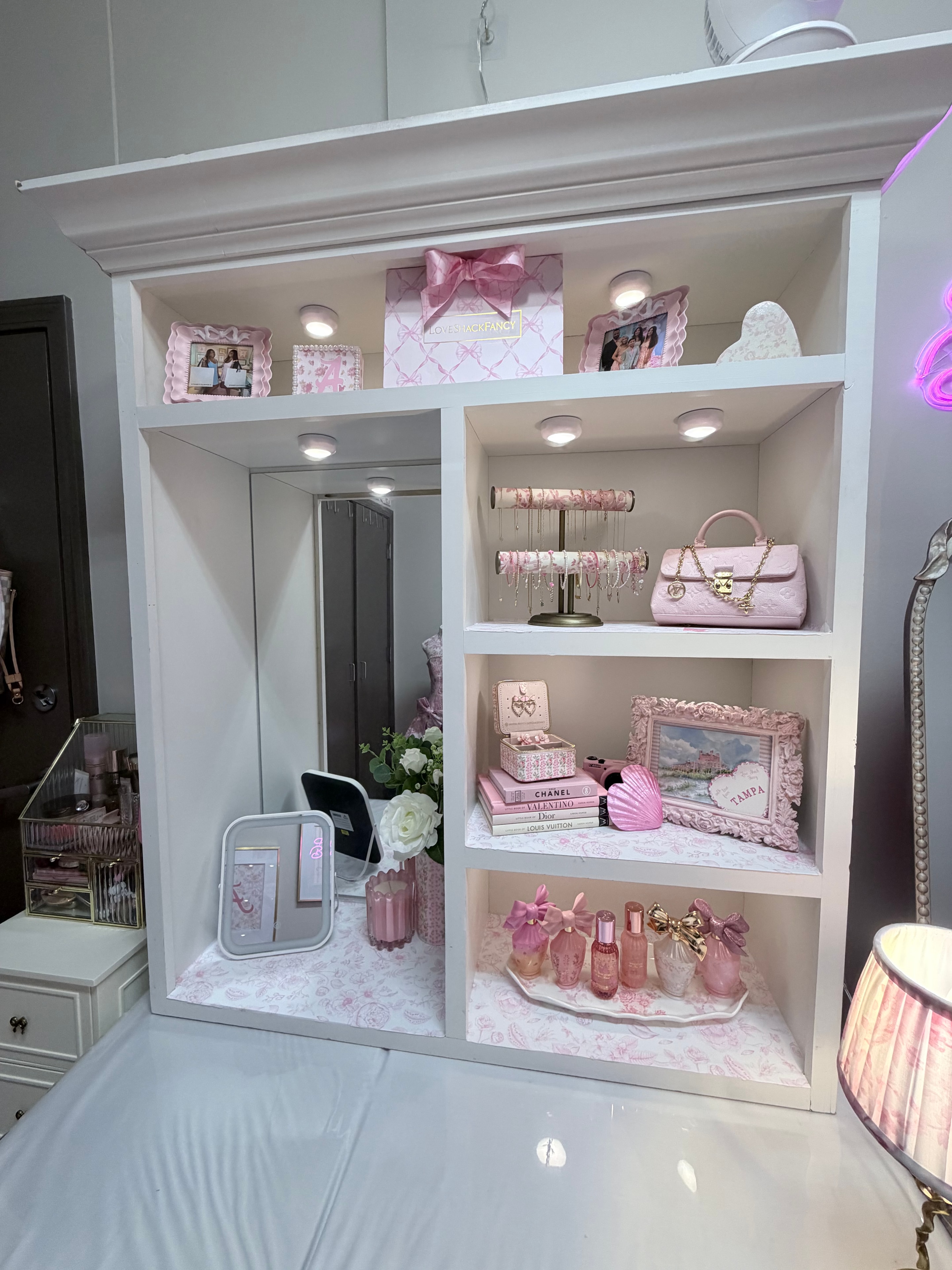 Styled vanity desk with white roses and pink decor