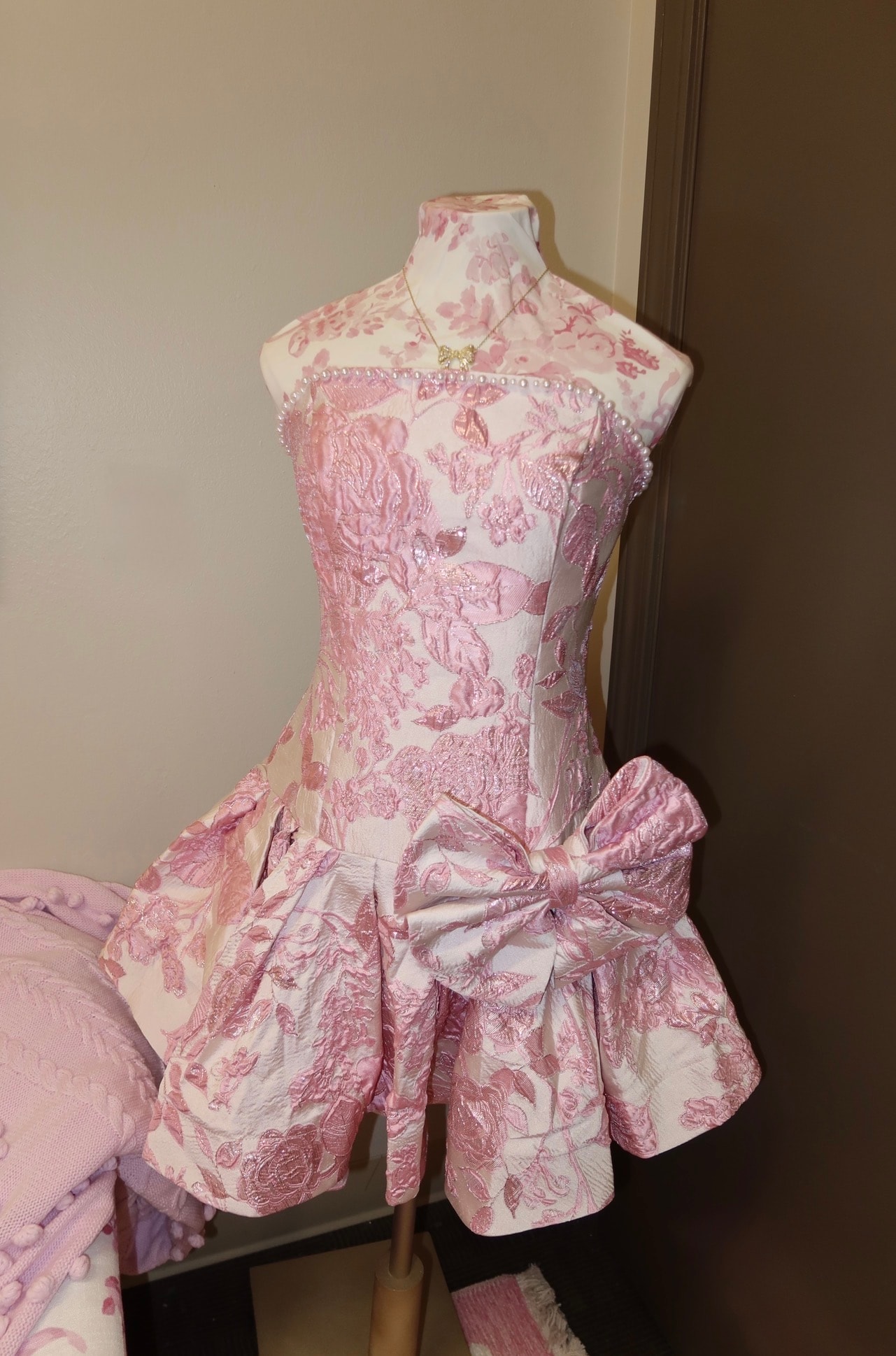Pink floral dress on dress form in Malaina's dorm room